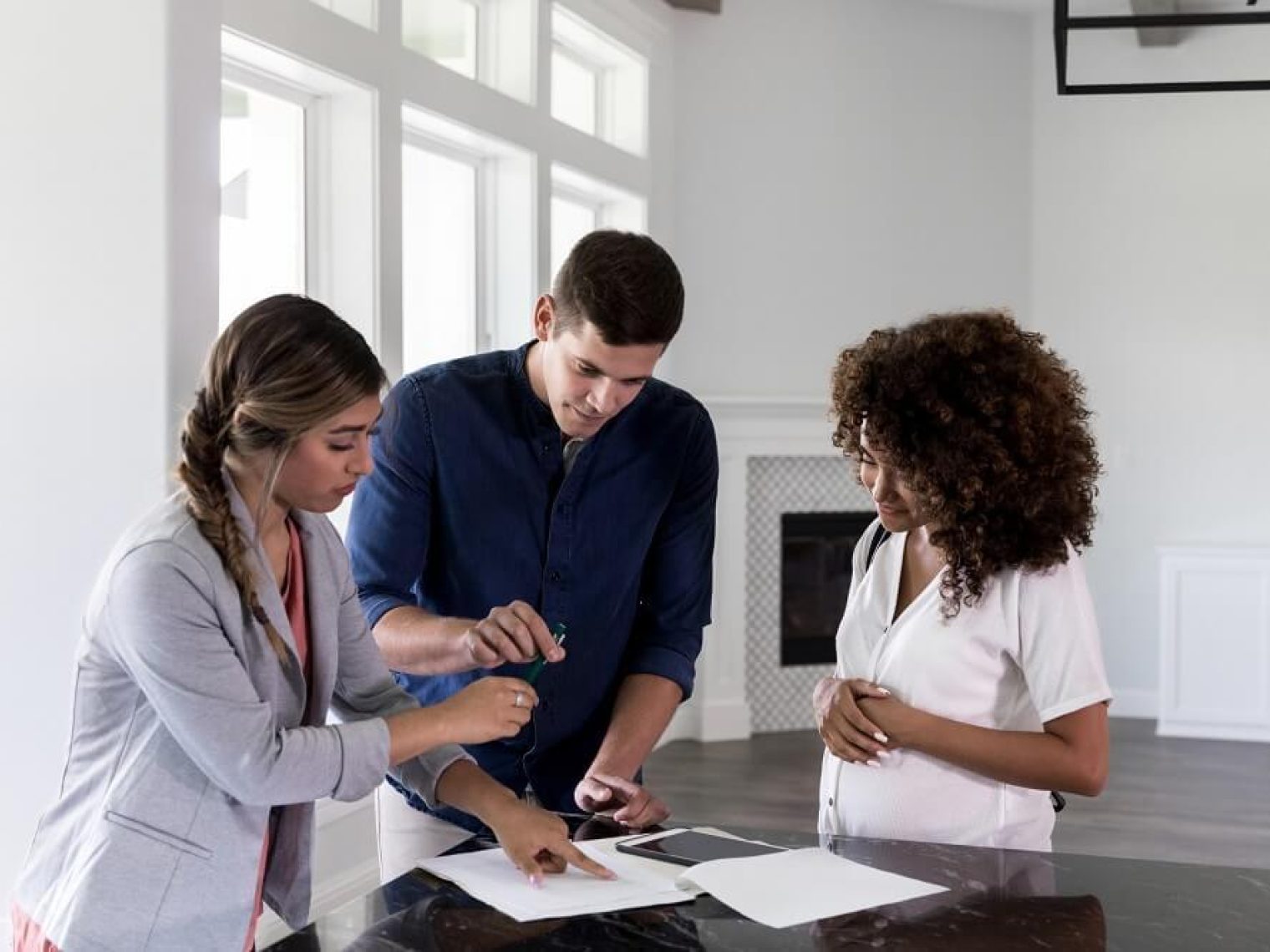 Couple reviewing paperwork with a real estate agent.