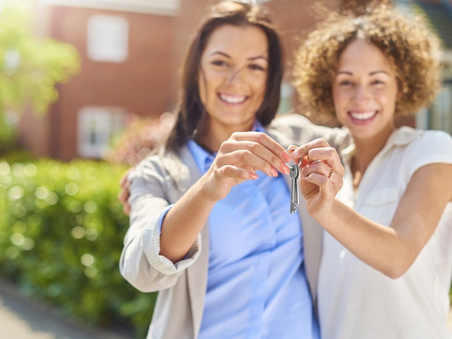 Married women hold house keys together.