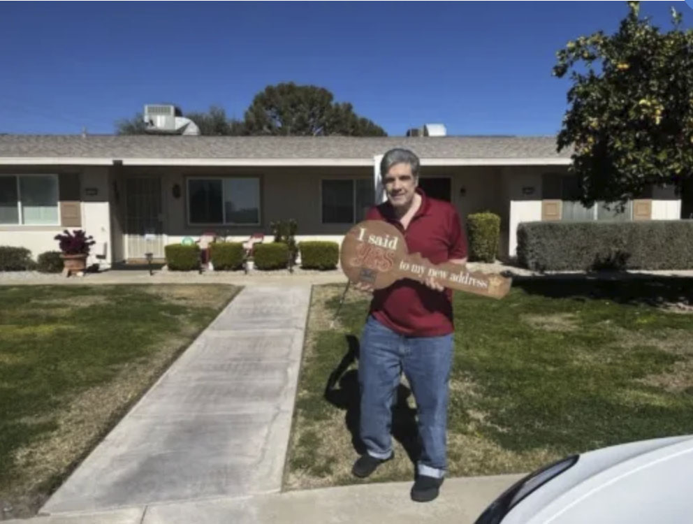picture of Alex S. in front of a house